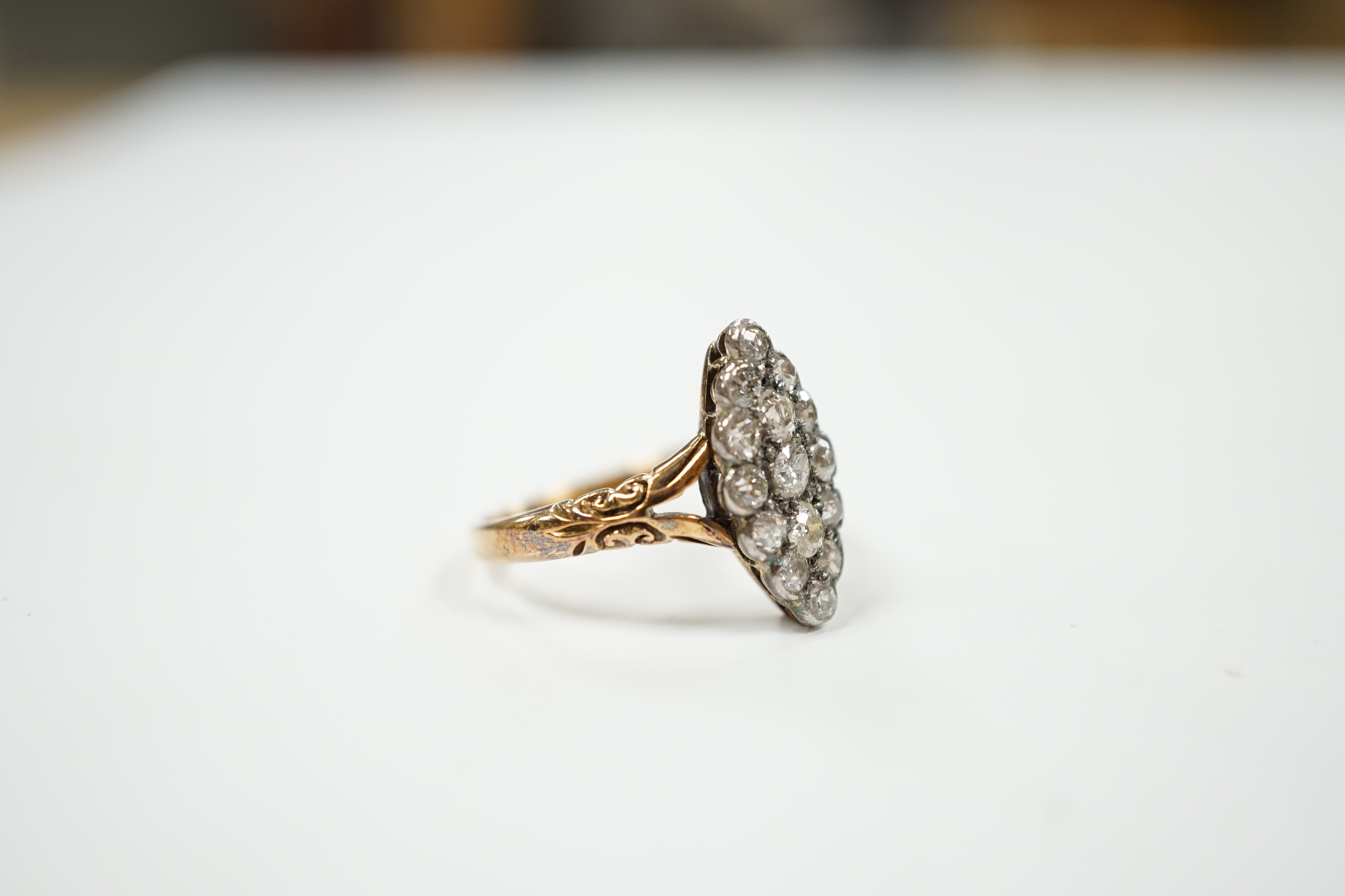 An 18ct and diamond set marquise cluster shaped ring, size N/O, gross weight 4 grams.